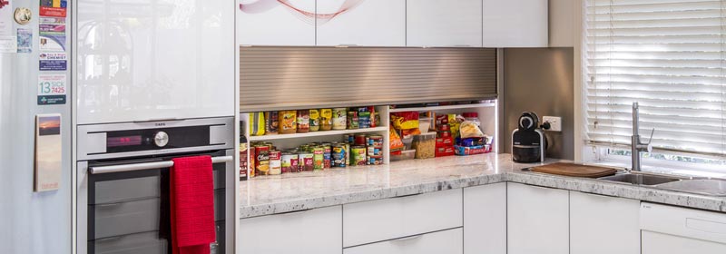 Tambour door in a benchtop Pantry configuration. Aluminium Gloss champagne colour.